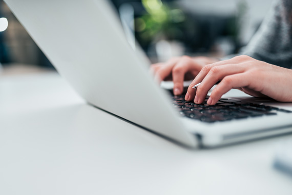 Person typing on laptop